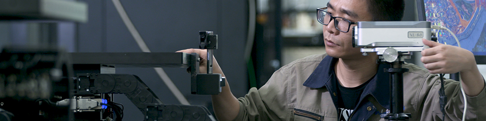 Engineer using the XL-80 laser to test and calibrate a motion stage