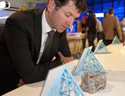 Simon Scott views a metal engine part printed on a Renishaw additive manufacturing machine