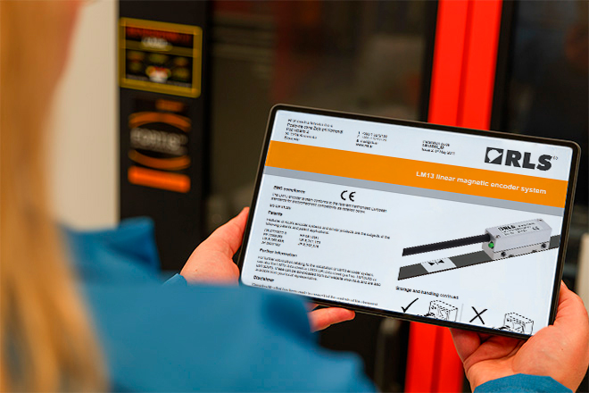 Tablet held by two hands and displaying a RLS encoders installation guide
