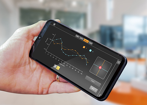 Hand holding a mobile device displaying test data from CARTO XK20 app