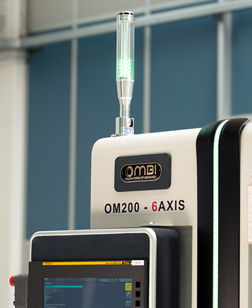 OMBI OM200 compact CNC machine close up of machine branding features