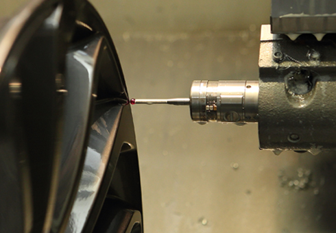 SAI - OLP40 performing in-process control of wheel production modelling.