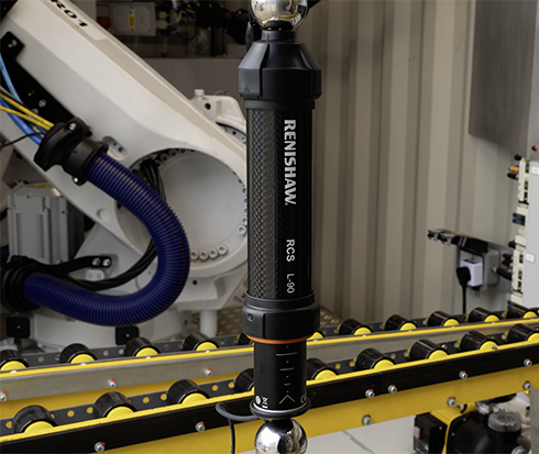 An RCS L-90 ballbar attached to an ABB robot inside a shipping container