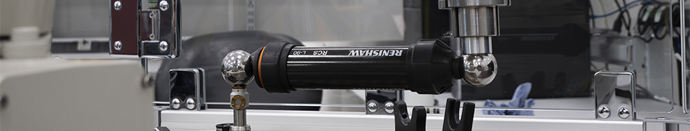 An RCS L-90 ballbar connected to the end-effector of an industrial robot whilst it performs a path performance test