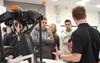 Engineer explaining the Equator™ gauging system to visiting students