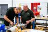 Engineers at MTT working on a piece of equipment