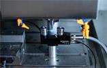 NC4+ Blue F100 measuring a tool on machine with laser beam