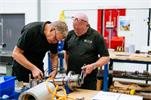 Engineers at MTT working on a piece of equipment
