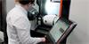 Engineer setting up XM-60 multi-axis calibrator in a machine