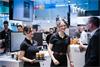 Employees offering refreshments at Control 2025
