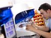 Worker 2 close to milling machine, lid up, billet tilted