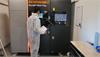 Tronosjet case study 9 - operator monitoring the RenAM 500 Flex during a build in progress.