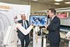David Cameron and Sir David McMurtry pictured with the neuromate surgical robot