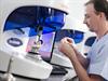 Dental technician looking at model