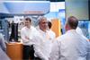 Employees having discussions on Control stand 2025